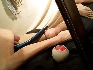 Subby lad teases his snatch with a dildo, edging towards a climax with a vibrator. His foot fetish is on full display, adding to the erotic atmosphere of this solo gay anal adventure.