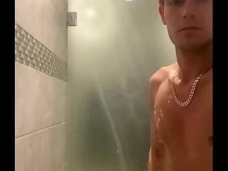 Steamy gym shower scene with a twist. A twink, locked in chastity, encounters a mature gym rat. Their erotic encounter unfolds in the locker room, igniting a primal desire. Raw, real, and fetish-filled.